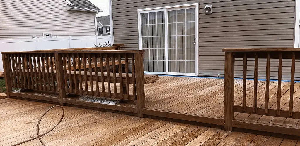 Deck sealing service protecting a backyard wood deck and railings in Baltimore, MD