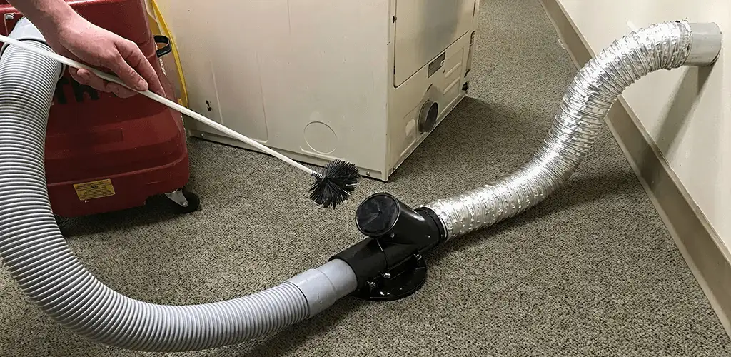 Dryer vent cleaning service removing lint from a dryer duct connection in Baltimore, MD
