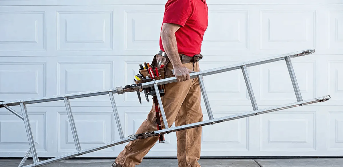 Garage door repair technician arriving with tools and ladder in Baltimore, MD