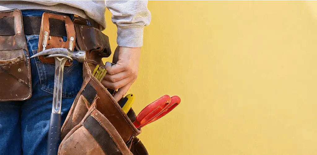 Handyman with tool belt ready for home repairs and maintenance in Baltimore, MD