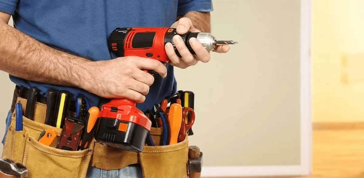 Handyman holding a power drill for home repairs and installations in Baltimore, MD