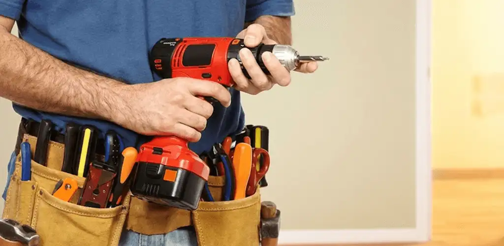 Handyman holding a power drill for home repairs and installations in Baltimore, MD