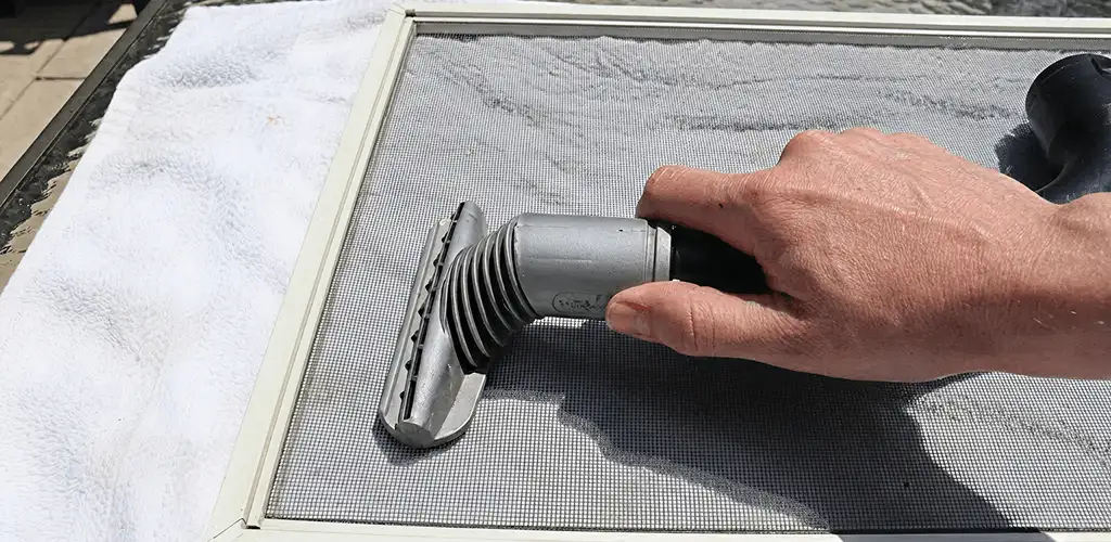 Window screen repair cleaning and fixing a damaged screen mesh in Baltimore, MD